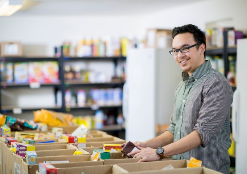 Photo of man packing food boxes