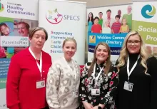 Four SPECS Bray female staff members standing in front of SPECS, Sláintecare and Wicklow Community Directory banners.